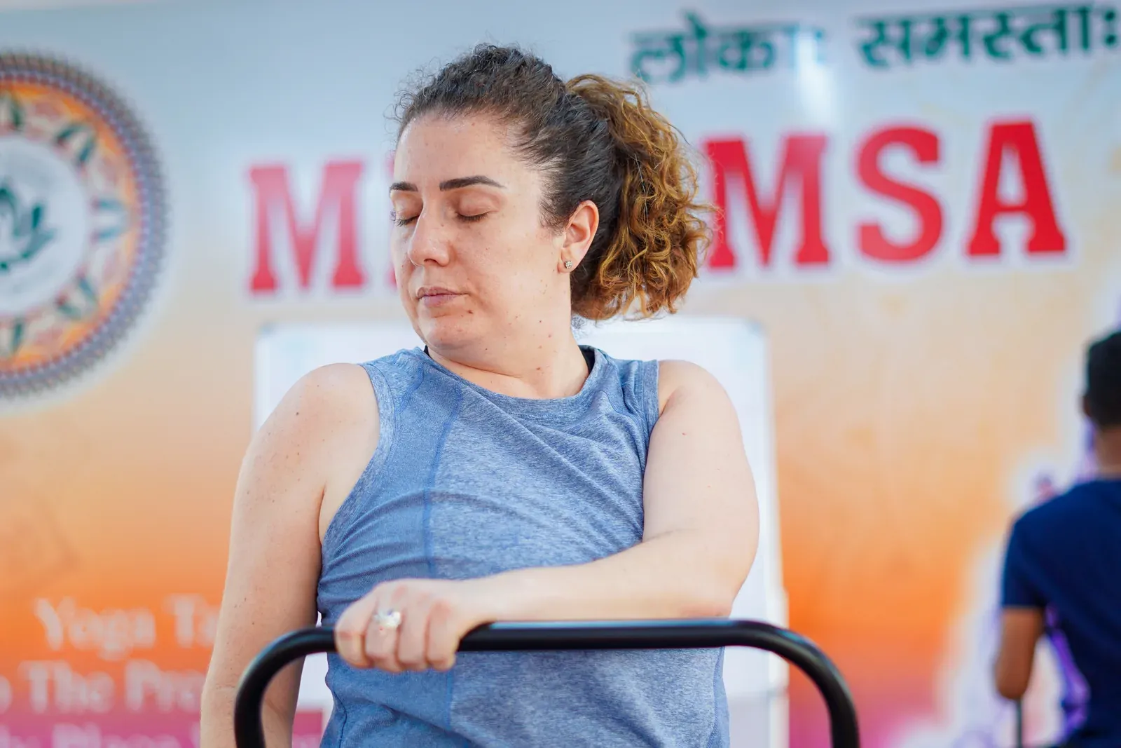 8 best chair yoga poses — seated spinal twist demonstration at Mimamsa Yogshala, Rishikesh